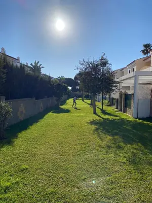a person riding a skateboard in a yard at Adosado Casa Melo Playa la Barrosa La Balconera in Poblado de Sancti Petri