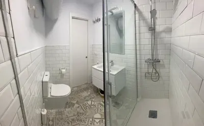 a bathroom with a shower and a toilet and a sink at Adosado Casa Melo Playa la Barrosa La Balconera in Poblado de Sancti Petri