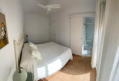 a white bedroom with a bed and a window at Adosado Casa Melo Playa la Barrosa La Balconera in Poblado de Sancti Petri