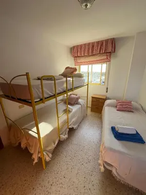two bunk beds in a room with a window at Apartamento Ana in El Puerto de Santa María