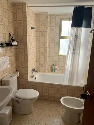 a bathroom with a tub and a toilet and a sink at Apartamento Ana in El Puerto de Santa María
