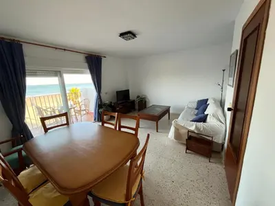 a living room with a table and a dining room with a view at Apartamento Ana in El Puerto de Santa María