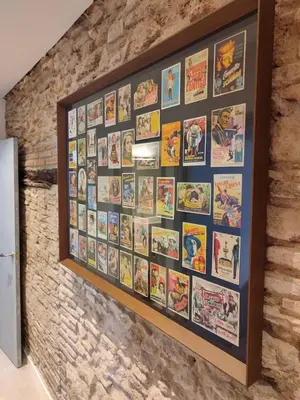a wall of movie posters on a brick wall at Mina25 by 7Escalones in Rota