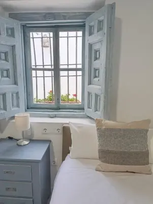a bedroom with a bed and a window at Mina25 by 7Escalones in Rota