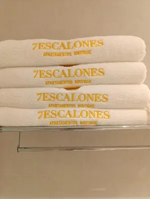 a stack of towels on a shelf in a bathroom at Mina25 by 7Escalones in Rota