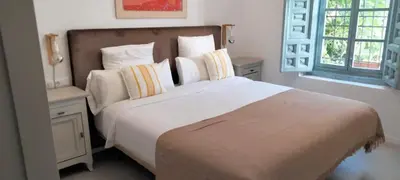 a bedroom with a large white bed and a window at Mina25 by 7Escalones in Rota