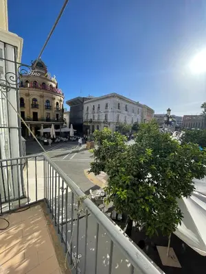 a bedroom with a bed and a table in it at Apartamento Gallo Azul in Jerez de la Frontera
