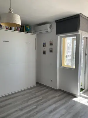 a room with a white refrigerator and a window at Azvalia estudio Valdelagrana in El Puerto de Santa María