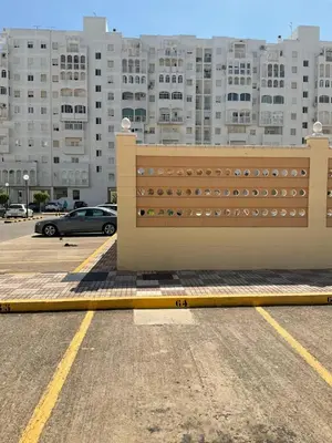 a fence in a parking lot in front of a building at Azvalia estudio Valdelagrana in El Puerto de Santa María