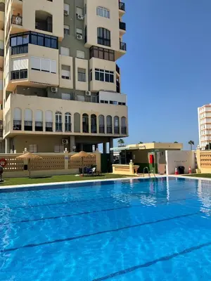 a swimming pool in front of a building at Azvalia estudio Valdelagrana in El Puerto de Santa María