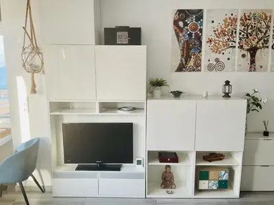 a white entertainment center with a flat screen tv at Azvalia estudio Valdelagrana in El Puerto de Santa María