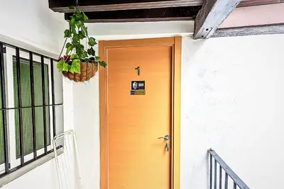 a yellow door on the side of a house at Milagros Central Apartments in El Puerto de Santa María