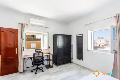 a home office with a desk and a window at Torre Argantonio by LiveWork in Cádiz