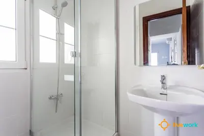 a white bathroom with a sink and a shower at Torre Argantonio by LiveWork in Cádiz