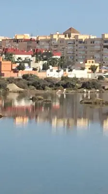 a body of water with a city in the background at Mi pisito La Maña in San Fernando