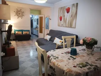 a living room with a table and a couch at Mi pisito La Maña in San Fernando