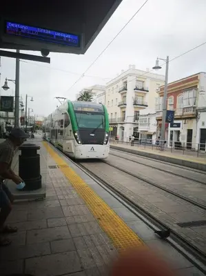 a green and white bus at a train station at Mi pisito La Maña in San Fernando