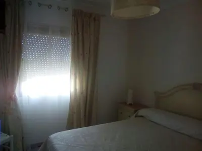 a bedroom with a bed and a window at Mi pisito La Maña in San Fernando