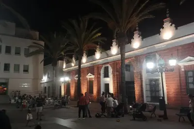 a group of people standing outside of a building at night at Mi pisito La Maña in San Fernando