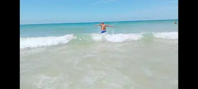 a man standing on a wave in the ocean at Vacaciones en Novo Sancti Petri in Chiclana de la Frontera