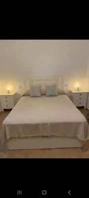 a bedroom with a large bed with two pillows at Apartamento Donna Elvira in Caserío Bogás