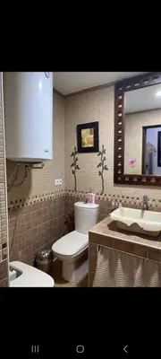 a refrigerator in a bathroom with a sink and a mirror at Apartamento Donna Elvira in Caserío Bogás