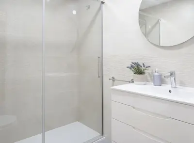 a bathroom with a glass shower and a sink at Chalet Pareado & Piscina in El Puerto de Santa María