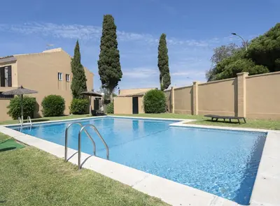 a swimming pool in the yard of a house at Chalet Pareado & Piscina in El Puerto de Santa María