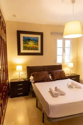 a bedroom with a bed with two towels on it at Alameda by Gades Gestión in Cádiz