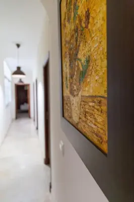a painting hanging on a wall in a hallway at Alameda by Gades Gestión in Cádiz