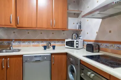 a kitchen with a sink and a microwave at Alameda by Gades Gestión in Cádiz