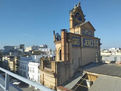an old building with a clock tower on top at ÁTICO Edificio RIANAL in Jerez de la Frontera