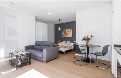 a living room with a couch and a table at ÁTICO Edificio RIANAL in Jerez de la Frontera