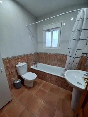 a bathroom with a toilet and a tub and a sink at Villa TRANQUILA in Chiclana de la Frontera