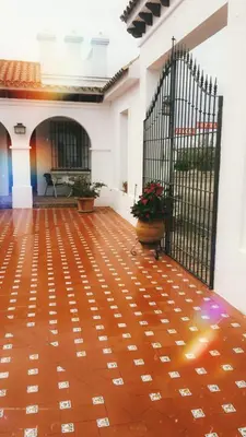 a room with a black gate and a wooden floor at Hotel Arcos-Coruña in Arcos de la Frontera