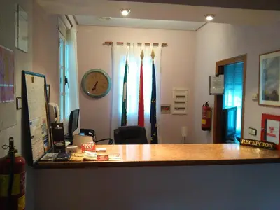 an office with a desk and a clock on the wall at Hotel Arcos-Coruña in Arcos de la Frontera