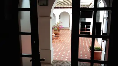 a view of a courtyard through an open door at Hotel Arcos-Coruña in Arcos de la Frontera