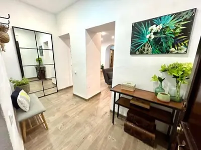 a living room with a table and some plants at GATU Castillo , 