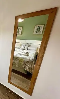 a mirror reflecting a bed in a bedroom at GATU Castillo , 