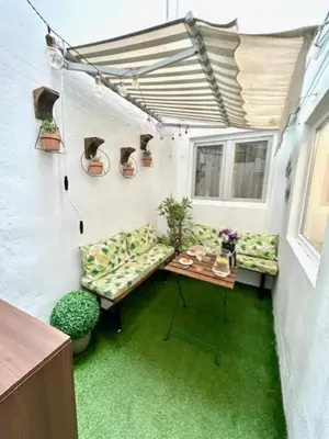 a room with a couch and a table in a building at GATU Castillo , 