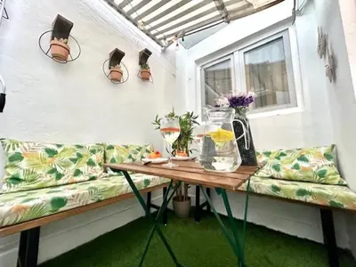 a porch with a couch and a table and a window at GATU Castillo , 