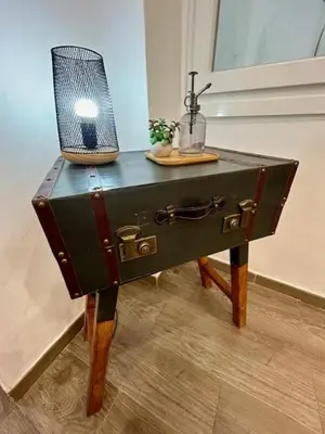 a small table with a suitcase on top of it at GATU Castillo , 