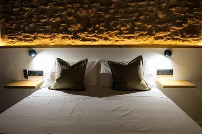 a bedroom with a white bed with two pillows at El Sur Medina-Sidonia in Medina Sidonia