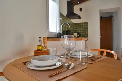 a wooden table with a bowl and glasses on it at El Sur Medina-Sidonia in Medina Sidonia