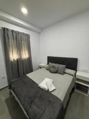 a bedroom with a large bed with two towels on it at Lacana in Chiclana de la Frontera
