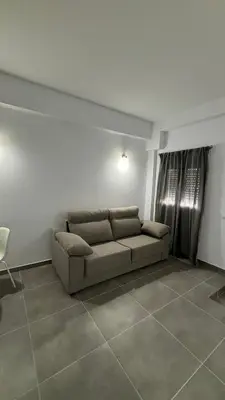 a living room with a couch in a room at Lacana in Chiclana de la Frontera