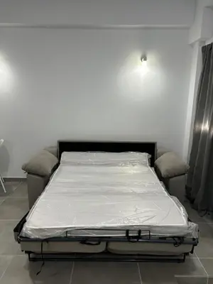a bed in a room with a white mattress at Lacana in Chiclana de la Frontera