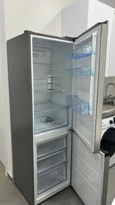 an empty refrigerator with its door open in a kitchen at Lacana in Chiclana de la Frontera