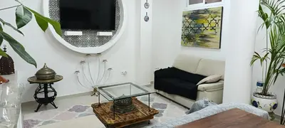a bedroom with a bed and a table and chairs at apartamentos el circulo mágico in Arcos de la Frontera