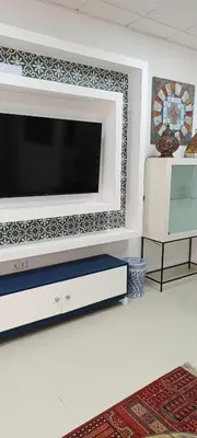 a kitchen with a microwave and a computer on a counter at apartamentos el circulo mágico in Arcos de la Frontera